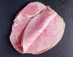 Wiltshire ham slices on stone board background