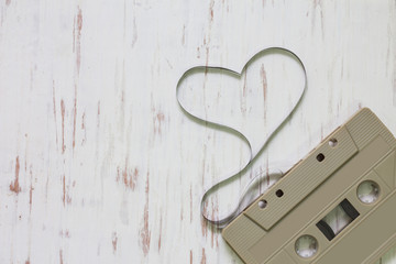 Vintage cassette tape on white rustic wooden background