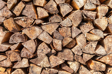 Chopped and stacked up dry firewood as background