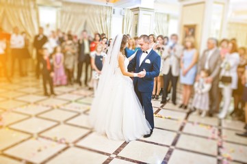 Wonderful wedding newlyweds dancing at the restaurant with light