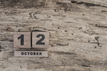 Cube calendar for october on wooden background with copy space