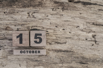 Cube calendar for october on wooden background with copy space