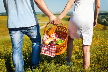 Young couple going with picnic basket