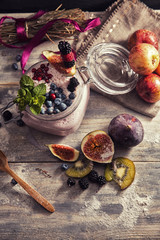 bright detox smoothie with berries on wooden background bowl