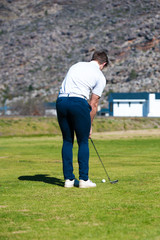 golfer playing a chip shot onto the green