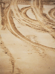 footprints in the sand, tire tracks