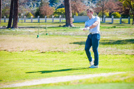 golfer playing a chip shot onto the green