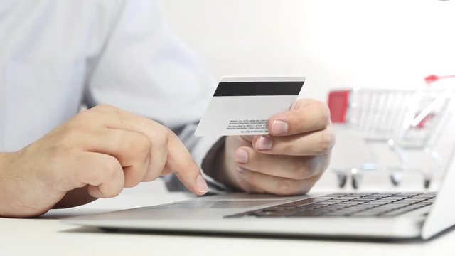 Man with laptop using credit card. Internet shopping concept.