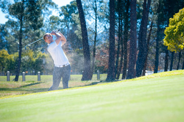 golfer playing a chip shot onto the green