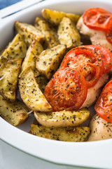 Dry basil parmesan fries and tomato chicken oven baked close up.
