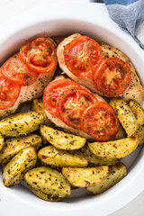 Dry basil parmesan fries and tomato chicken oven baked top view on white background.
