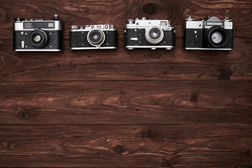 A set of four old-fashioned cameras with a copy space