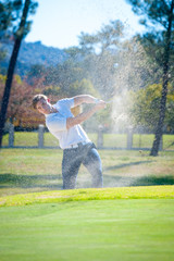 golfer playing a chip shot onto the green