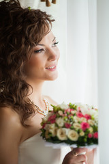 Beautiful young bride with wedding makeup and hairstyle in bedroom, newlywed woman final preparation for wedding. Happy Bride waiting groom. Marriage Wedding day moment. Bride portrait soft focus