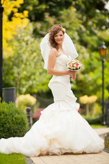 Charming Bride with Wedding Tiara on Nature Background. Modern Bridal Style. Toned Photo with Copy Space.