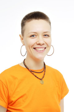 Close-up portrait of smiling beautiful girl. Over white background. Smiling girl in an orange T-shirt. Age defying skin care anti aging flawless spa treatment beautiful woman smiles