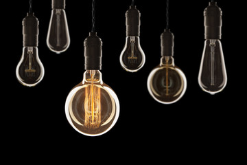 Fototapeta na wymiar Idea and leadership concept Vintage incandescent Edison bulbs on