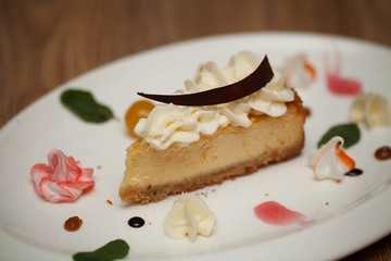 Apple pie with mint on a white plate on a wooden background