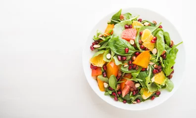 Gordijnen Fresh salad with fruits and greens on white wooden background top view with space for text. Healthy food. © elenabdesign