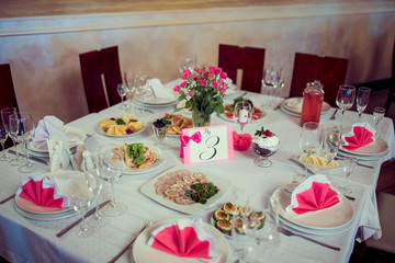 Beautiful wedding day ceremony set up. Indoor. Good served table in a restaurant.