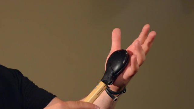 One Man Playing on the Percussion Instrument Castanets. on the Bright Walls Background.