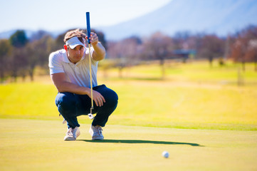 view of a golfer planning his shot to the pin