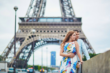 Romantic loving couple having a date near the Eiffel tower