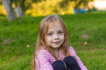 Portrait of a cute girl with long blond hair