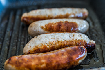 Close up of pan fried sausages