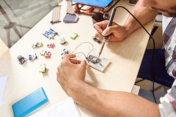 Skillful young man engineering 3d printer