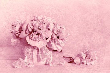 White peonies in a vase. Pink monochrome background