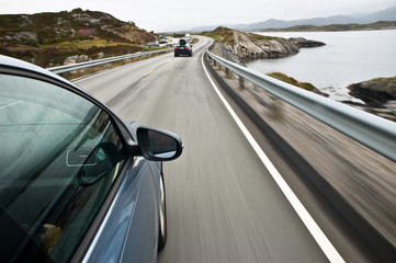 Obraz na płótnie Canvas car driving the Norwegian national road 64 known as the Atlantic road