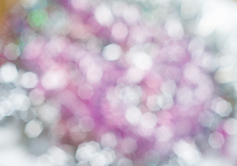Blurred background with bokeh lights in shades of  pink and green
