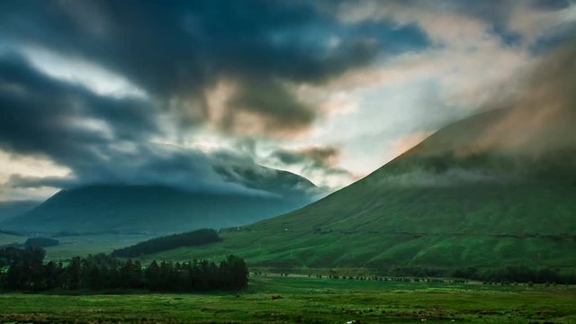 Beautiful foggy dawn over the mountains of Glencoe in Scotland, 4k, timelapse