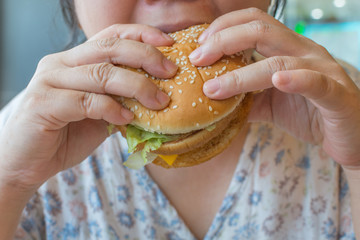 Asia woman eating a hamburger