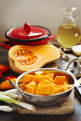 Preparing pumpkin, onions and sweet peppers for cooking