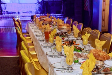 Beautifully decorated catering banquet table with different food snacks and appetizers