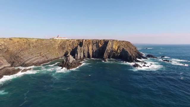 Lighthouse on cliff top - Cabo Sardao, Portugal aerial view