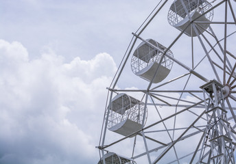 part of white Ferris Wheel on cloudy Sky