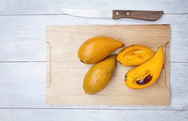 Canistel fruite on wooden cutting board