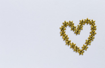 Golden star arrange in heart shape on white background