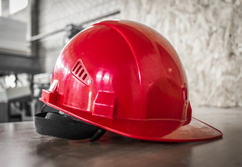Red hard hat on a table.