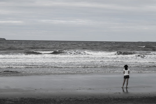 lonely girl on the beach (black-white tone)