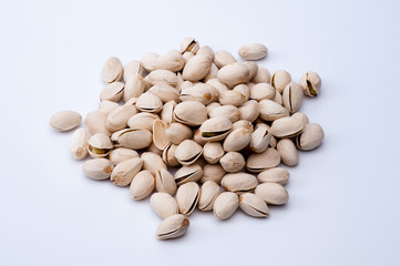 Roasted and salted pistachios in shell on white background