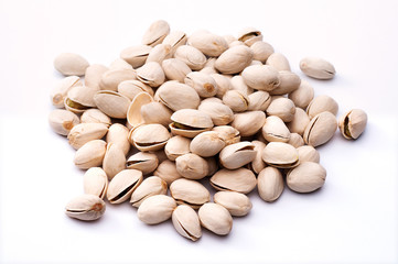 Roasted and salted pistachios in shell on white background