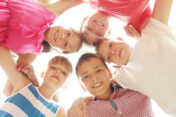 Happy kids standing in circle