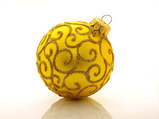 yellow christmas ball on white background with reflection