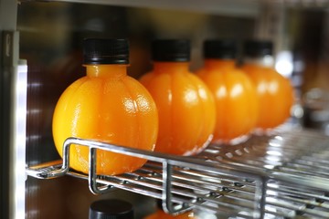 orange juice in circle bottle 