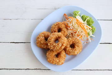Fried Prawn Cake (tod mun kung) in blue dish.