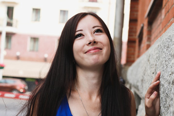 Portrait of a sexual girl near a brick wall